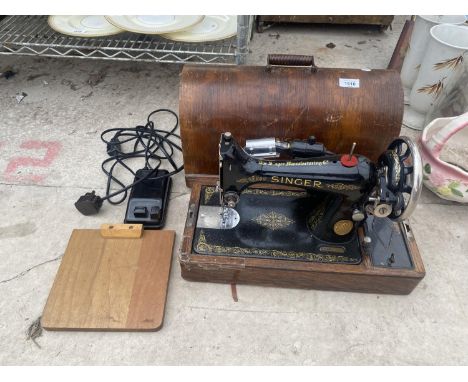 A VINTAGE SINGER SEWING MACHINE WITH WORK LIGHT AND WOODEN CARRY CASE 