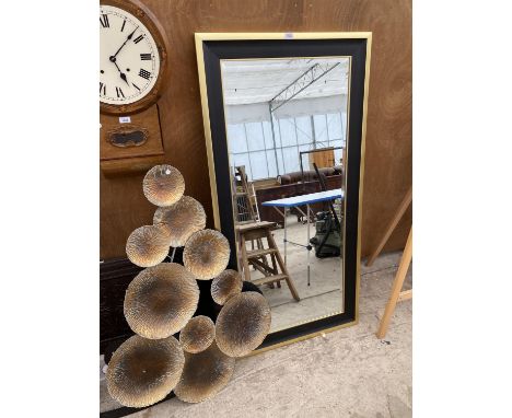 A MODERN GILT AND BLACK FRAMED BEVELED EDGE MIRROR AND A DECORATIVE WALL MOUNTING 