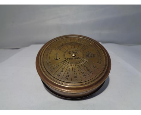 A BRASS CALENDER COMPASS 