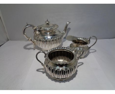 A SMALL SILVER TEAPOT SET 