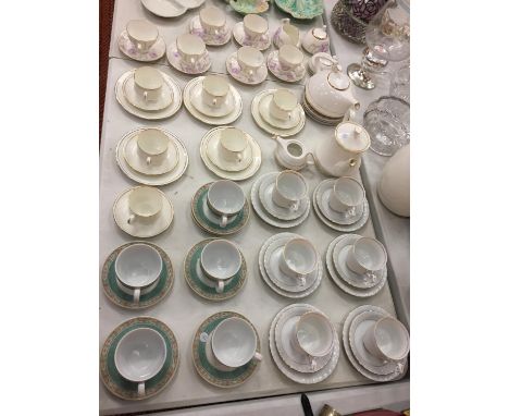 A LARGE COLLECTION OF VARIOUS TEA CUPS AND SAUCERS OF VARIOUS DESIGNS AND TWO TEAPOTS 