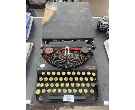 A VINTAGE REMINGTON PORTABLE TYPE WRITER 