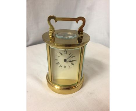 A CYCLINDRICAL BRASS CARRIAGE CLOCK 