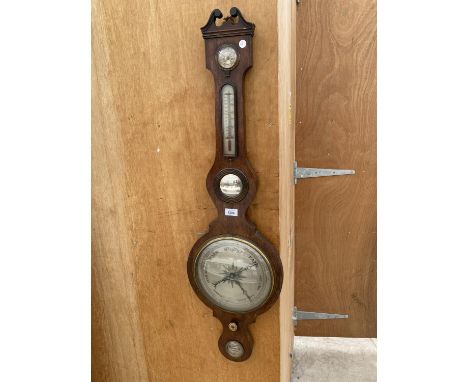 A LARGE DECORATIVE OAK BAROMETER 