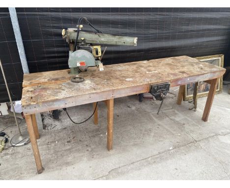 A LARGE INDUSTRIAL HEAVY DUTY WORK BENCH WITH RECORD BENCH VICE AND DEWALT CIRCULAR SAW 