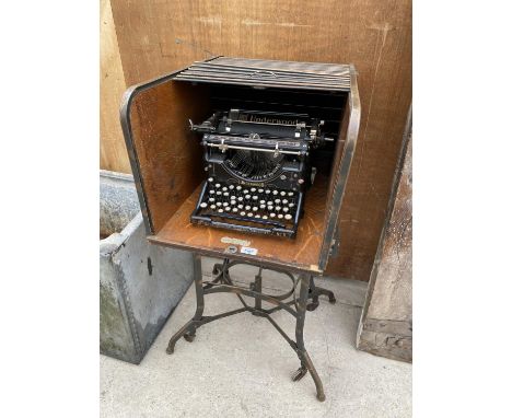 AN INDUSTRIAL TYPEWRITER TABLE/STAND DESK MANUFACTURED BY TOLEDO AND CONTAINING AN UNDERWOOD VINTAGE TYPEWRITER 