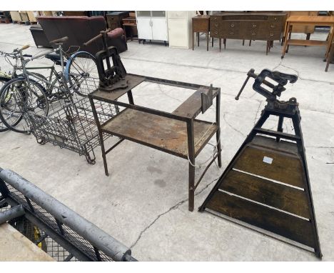 A HEAVY DUTY METAL WORK BENCH WITH A LARGE PIPE VICE, A PIPE VICE ON A STAND AND A GALAVANISED MESH CRATE 