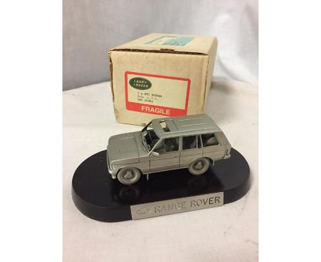 A PEWTER LAND ROVER RANGE ROVER ON A PLINTH WITH A BOX 