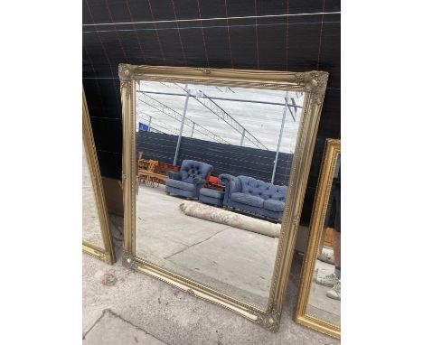 A LARGE DECORATIVE GILT FRAMED OVER MANTLE MIRROR 