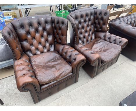 A PAIR OF BROWN BUTTON BACK WINGED EASY CHAIRS 