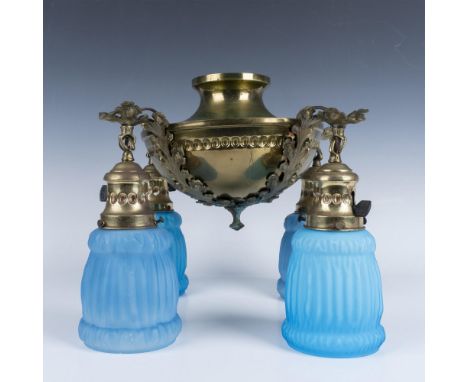 Layered brass round flush mount design with four arm lighting accented by sky blue pleated satin glass shades. Each arm has i