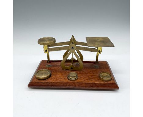Brass scale with 1/2 oz. to 2 oz. weights mounted to wooden base. Warranted Accurate and Made in England impressed mark. Issu