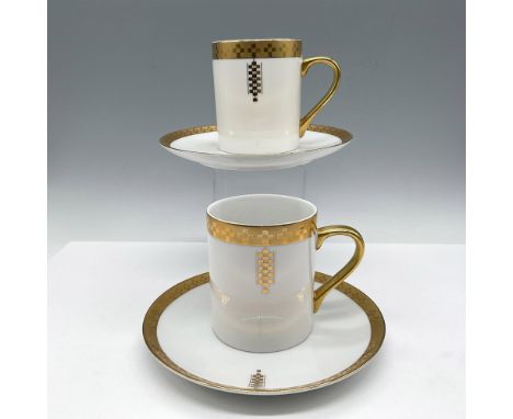 Inspired by a Frank Lloyd Wright architectural design over white porcelain on rim of cup and saucers. Gilt handle accents the