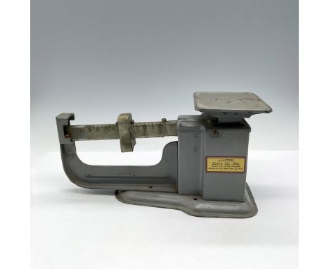 Gray metal scale with 9 oz. weight capacity. Screw at end of arm to rebalance scale. Allsteel Co. mark and Triner Steel impre