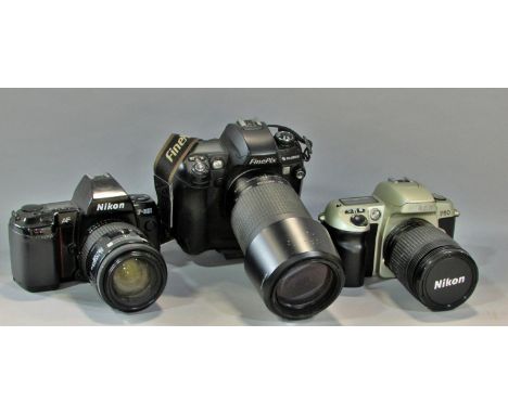 Three Nikon cameras models F60, F801, F4015 with a case together with a Fujifilm Finepix S3 PRO fitted with a Nikon zoom lens