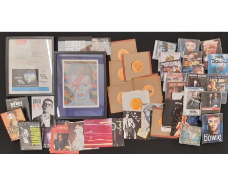 A collection of David Bowie related music and ephemera, to include: CDs, DVDs and Singles vinyl records; Ten stamps; A framed