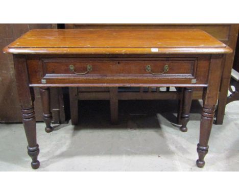 A Victorian stained pine side table of rectangular form with moulded outline over a frieze drawer raised on ring turned and t