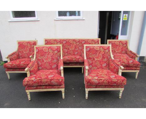 A French drawing room suite comprising a three seat sofa and four matching tub chairs, the frames with carved, painted and gi