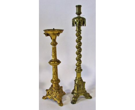 Two good 19th century ecclesiastical candlesticks: A heavy cast brass candlestick with arched guard over a twisted stem and p