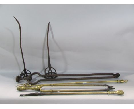 A substantial pair of 19th century rusty wrought iron coal tongs, together with three similar fire tools, an two branding iro