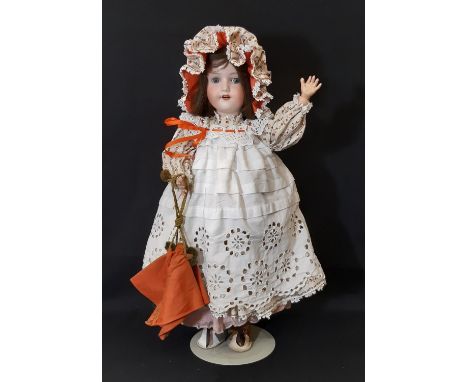 An early 20th century bisque head doll by Armand Marseille with jointed composition body, closing blue eyes, open mouth with 