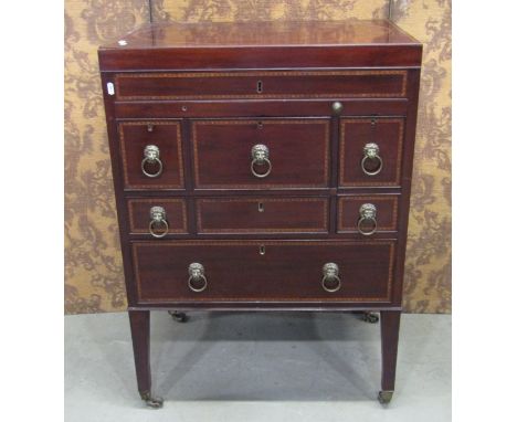 A Georgian mahogany gentleman's wash stand with rising lid, with comprehensively fitted interior, incorporating a writing slo