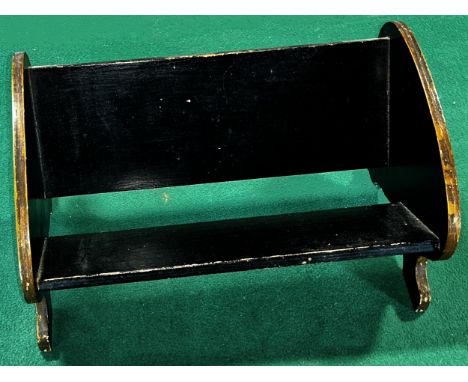 A black lacquered and painted book trough with hand painted Man of War sailing ships to the ends, 32cm wide, together with a 