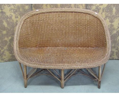 A vintage wicker two seat sofa, a mid century wicker plate glass occasional table of circular form and further matching chair