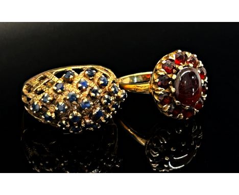 Two 1970s 9ct dress rings; a garnet oval cluster ring, maker 'G&amp;T.J', London 1977, size N/O, 3.7g and a blue spinel bombe