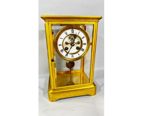 A 19th century French gilt brass cased four pane mantle clock, with enamelled chapter ring, 27cm high, 18 x 14cm 