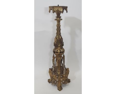 A large and impressive 19th century ecclesiastical gilt brass pricket candle stick, with arched cradle, raised on a complicat