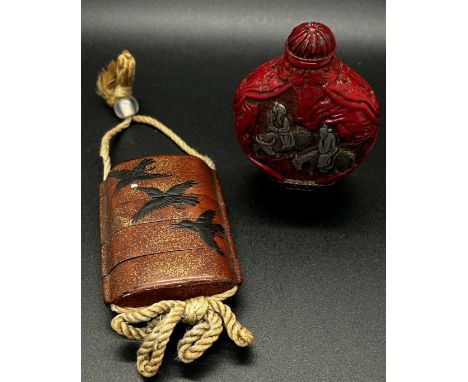 A four sectional Chinese lacquer inro of crows, two carved hard wood netsuke figures of animals and a snuff bottle and cover 