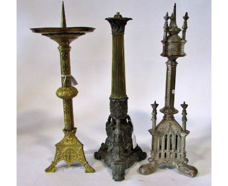 Three 19th century candlesticks / lamps: A gilt brass ecclesiastical brass example, with broad reservoir and dish, with embos