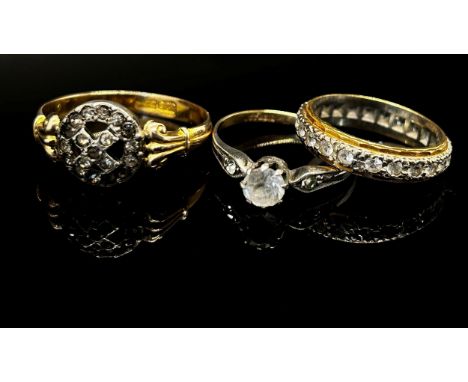 Three colourless stone rings comprising an 18ct bi-colour eternity ring, 4.3g, an antique 9ct X shaped cluster ring, 2.5g and