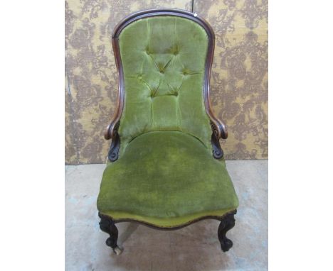 A Victorian drawing room chair with upholstered seat and button back with a shaped carved and moulded show wood frame, raised