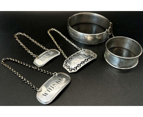 Three silver drinks labels - Whiskey, Port and Rum, varying sizes, together with a single napkin ring and a silver engraved b