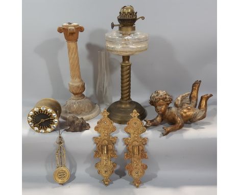 A decorative miscellaneous collection of items including, a gold flying cherub, two gilded wall brackets, a marble twisted co