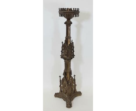 A 19th century continental brass ecclesiastical gothic candlestick, with a pointed hexagonal cradle over architectural stem a