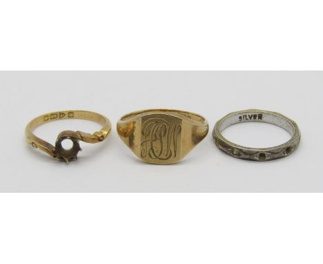 Three rings comprising a 9ct signet with engraved initials, 3.5g, an 18ct crossover ring, 2.5g (setting vacant) and a silver 