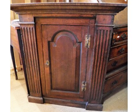 A 19th Century oak corner cupboard of architectural form
