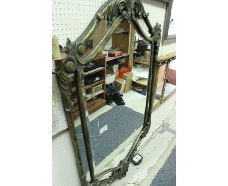 A seven section mirror with bevelled central pane in a metal frame with gilt scrollwork decoration