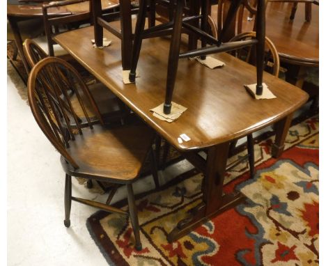 A mahogany Ercol dining table together with five Ercol stick back chairs together with two further stick back chairs and a pa