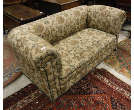 A Victorian drop end sofa with cream ground and floral patterned upholstery to bun feet