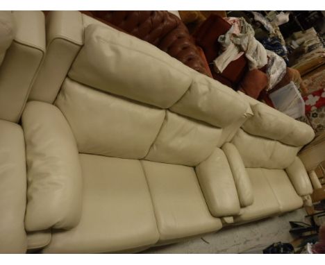 A large cream leather two seater sofa together with a matching smaller cream leather sofa and a matching cream leather armcha