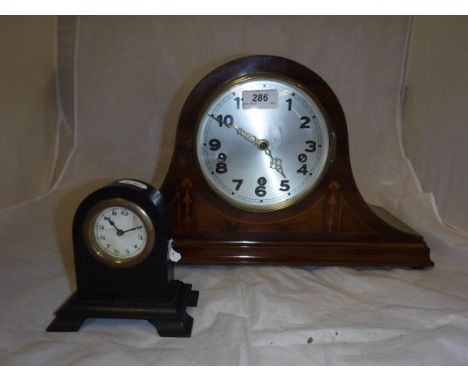 An Edwardian mahogany and inlaid cased mantel clock and an ebony cased mantel clock