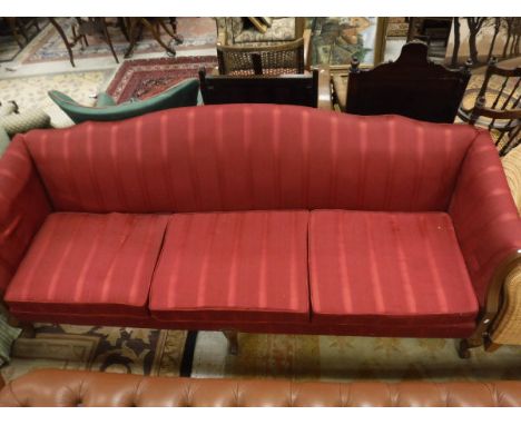 A Georgian style four seat sofa with red upholstery to carved cabriole legs 