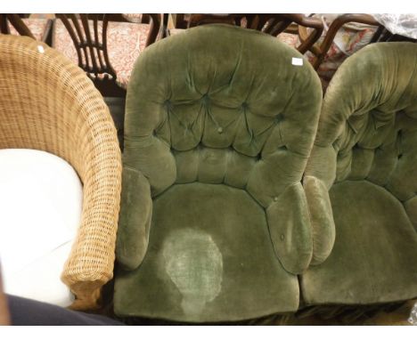 A pair of Victorian armchairs with green velvet upholstery, button back to turned front legs and casters together with a Vict