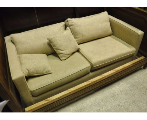 A modern cream upholstered two seat sofa bed