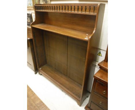 A mahogany bookcase with galleried top to integral shelf with three adjustable shelves to bracket feet