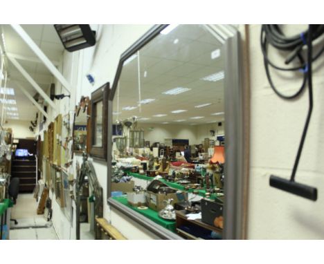 A large silver painted wooden framed mirror